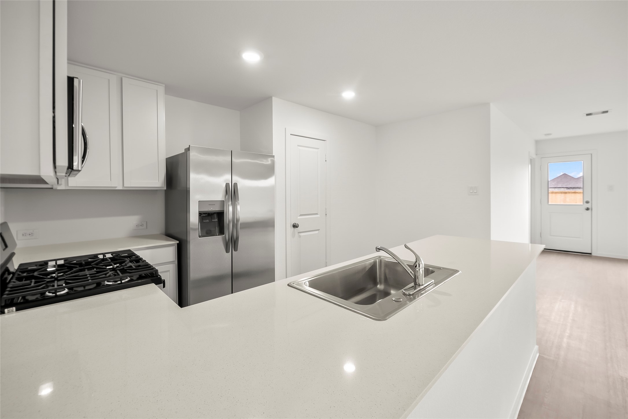 16102 Hatton Drive Conroe, TX 77303 - Photo 3 of 28 a kitchen with a refrigerator and a stove top oven