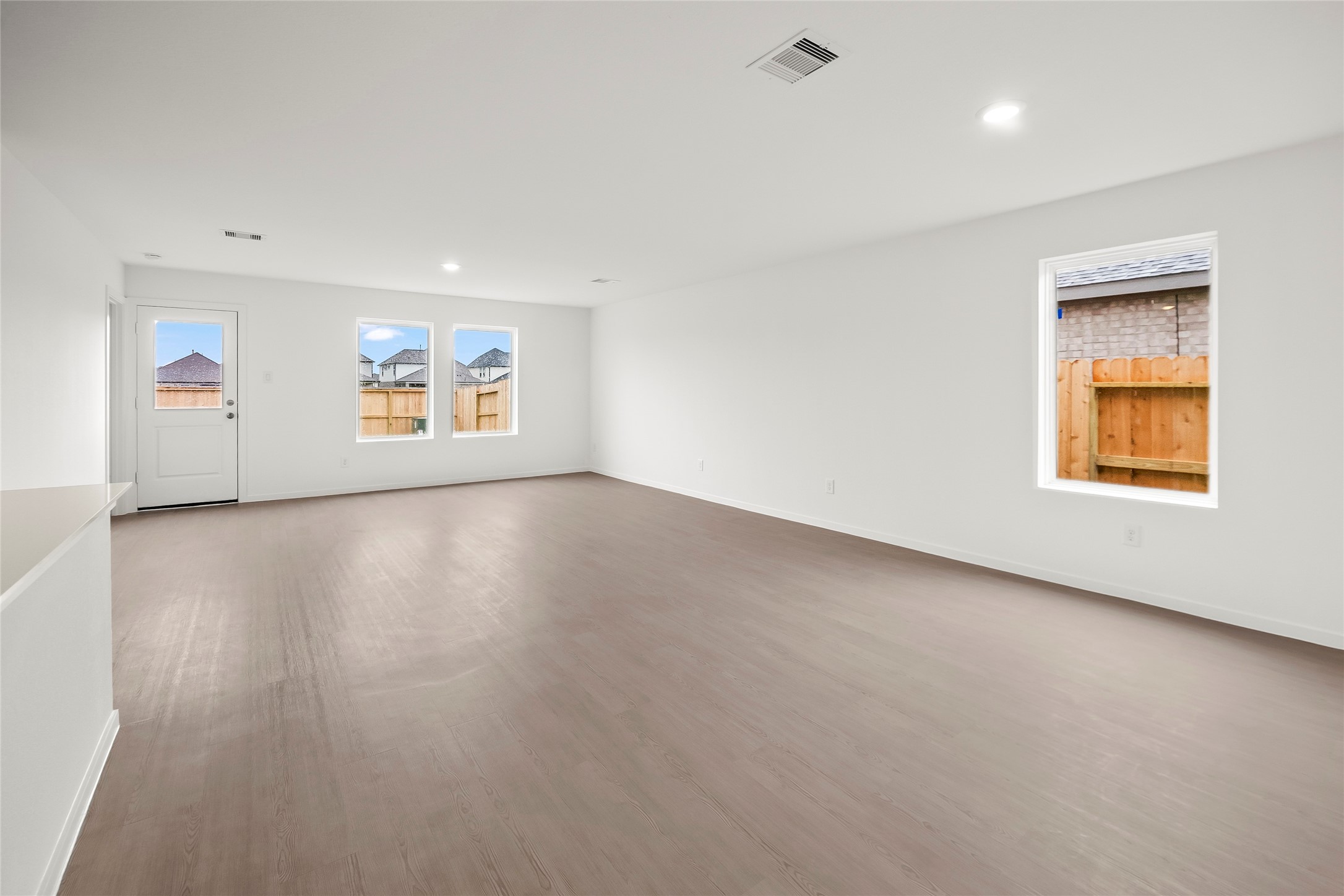 16102 Hatton Drive Conroe, TX 77303 - Photo 4 of 28 an empty room with windows and cabinet