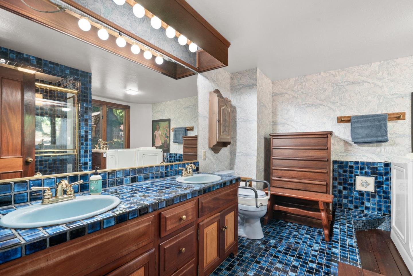 4611 Bonny Doon Road Santa Cruz, CA 95060 - Photo 22 of 94 a bathroom with a granite countertop sink toilet and shower