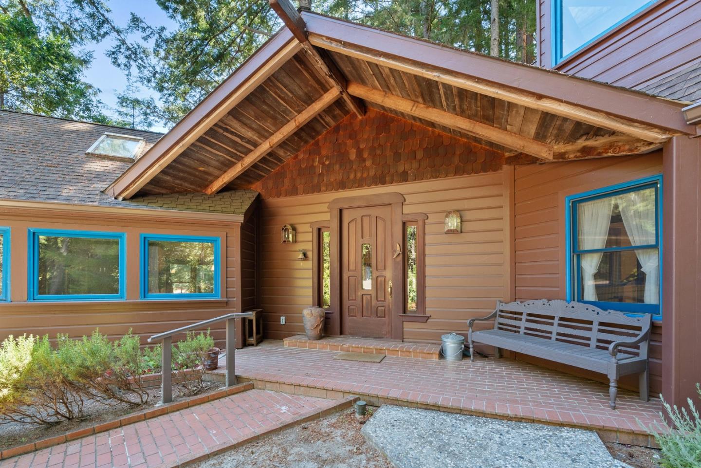4611 Bonny Doon Road Santa Cruz, CA 95060 - Photo 47 of 94 a backyard of a house with barbeque oven table and chairs