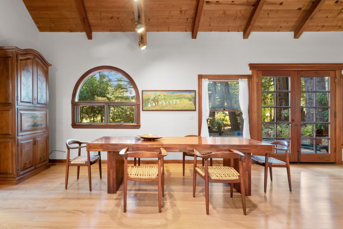 4611 Bonny Doon Road Santa Cruz, CA 95060 - Photo 51 of 94 a view of a dining room with furniture large windows and wooden floor