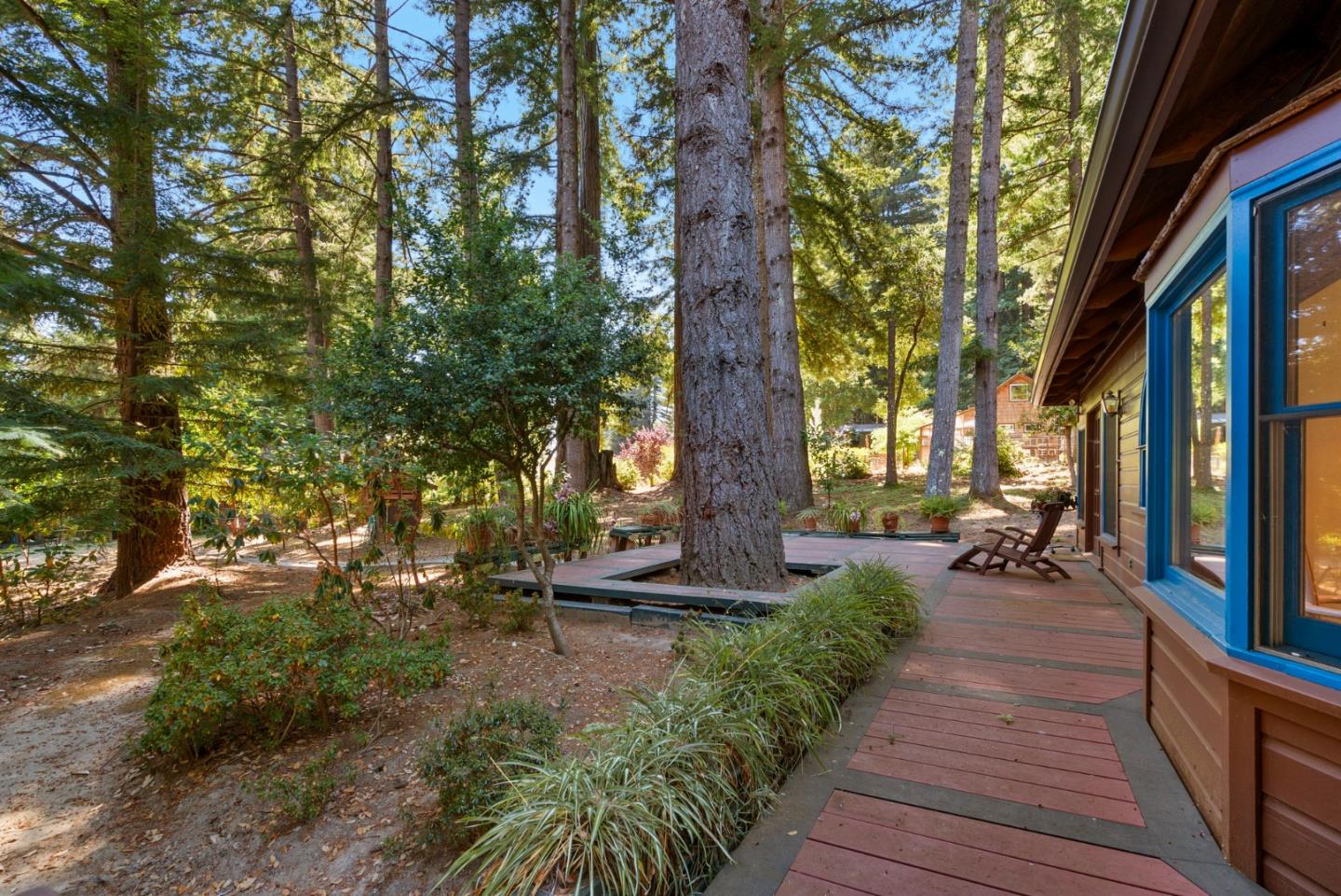4611 Bonny Doon Road Santa Cruz, CA 95060 - Photo 90 of 94 a view of a patio with table and chairs next to a yard