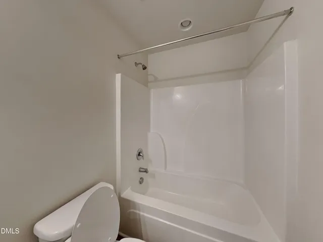 a bathroom with a shower and a toilet