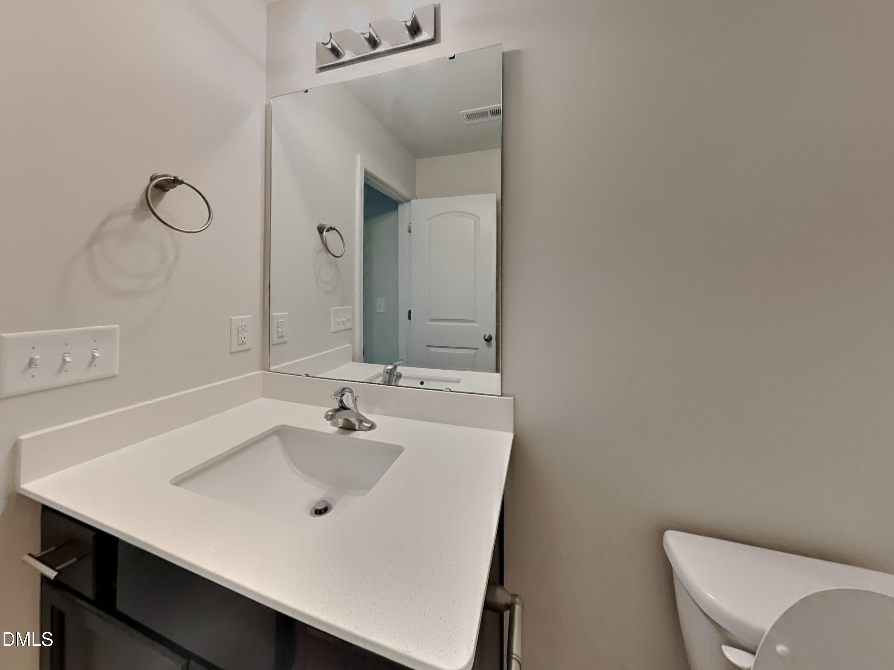 35 Drake Circle Bunnlevel, NC 28323 - Photo 14 of 17 a bathroom with a sink and a mirror