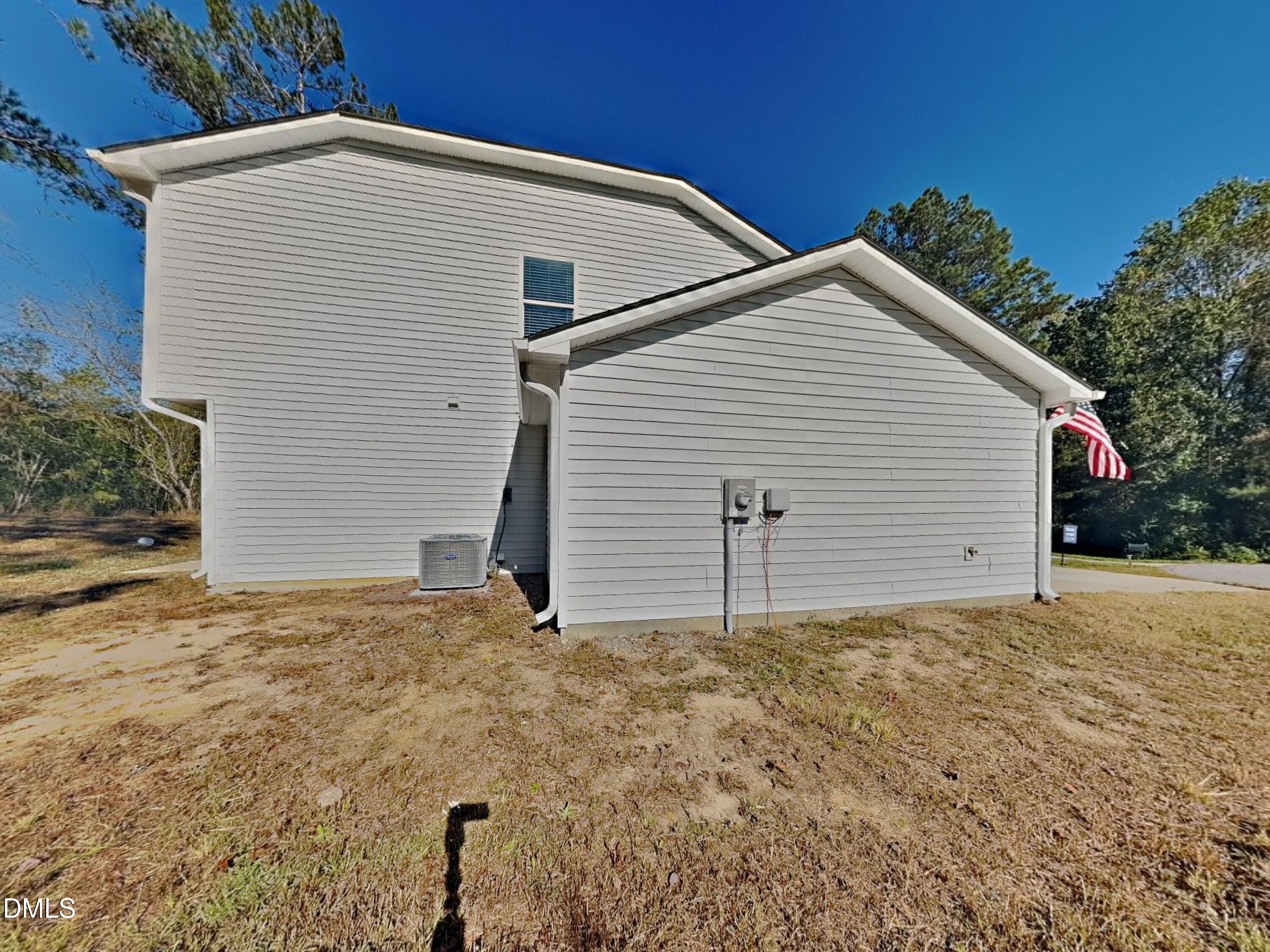 35 Drake Circle Bunnlevel, NC 28323 - Photo 16 of 17 a view of a white house with a yard and garage
