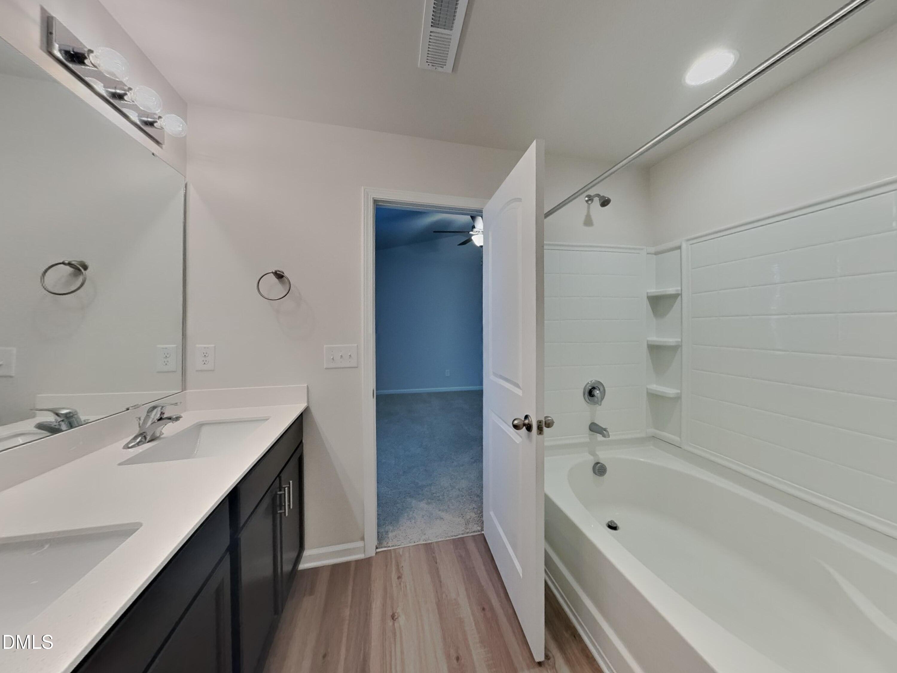 35 Drake Circle Bunnlevel, NC 28323 - Photo 7 of 17 a bathroom with a tub sink double vanity granite tub shower and mirror