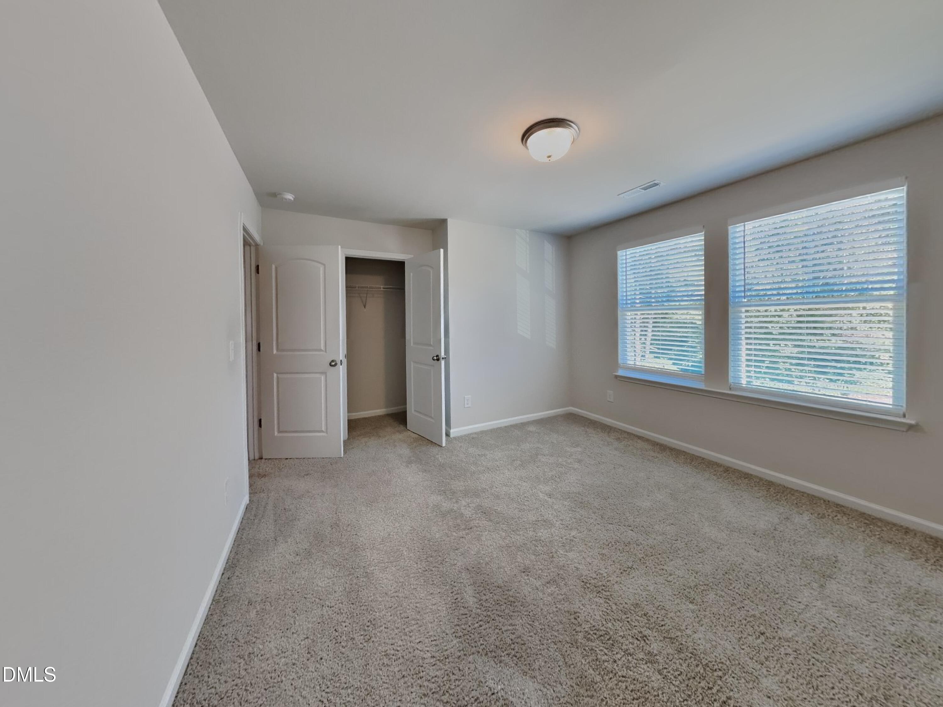 35 Drake Circle Bunnlevel, NC 28323 - Photo 10 of 17 an empty room with windows and closet