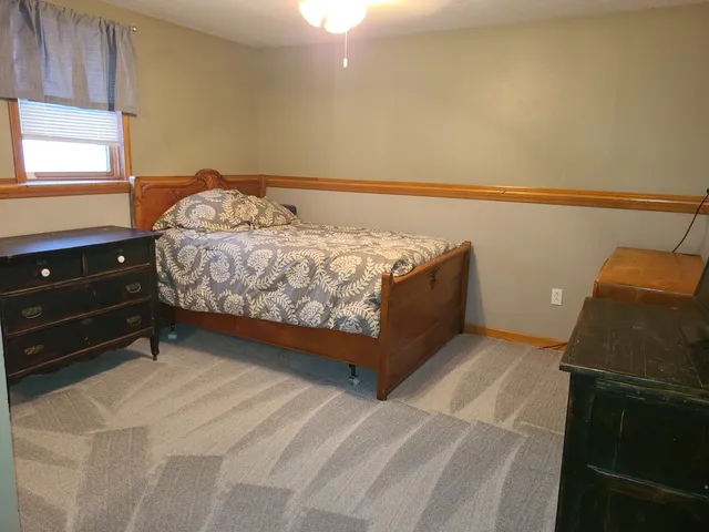 a bedroom with a bed and window
