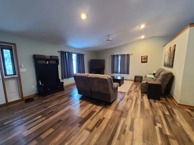 a living room with furniture and a wooden floor