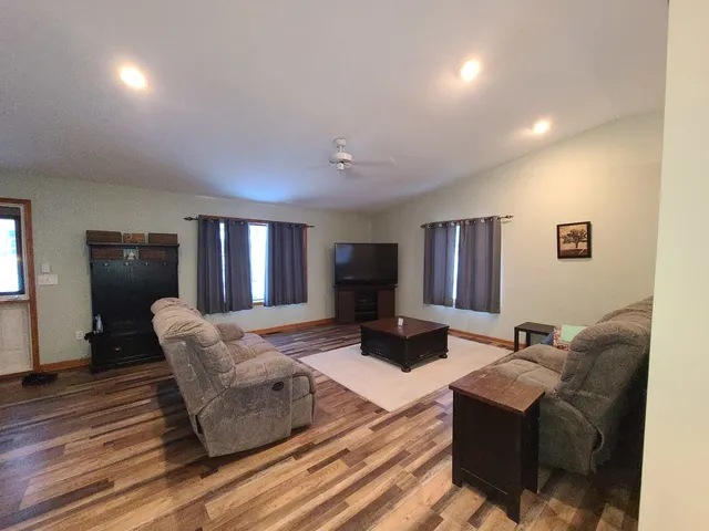 a living room with furniture fireplace and wooden floor