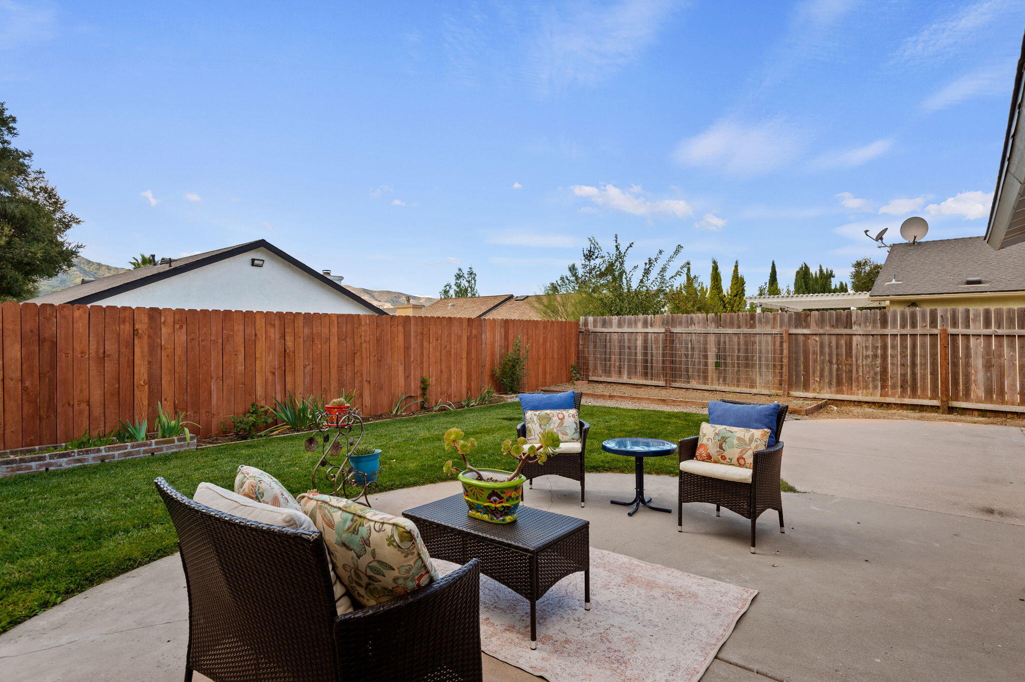 232 2nd Street Buellton, CA 93427 - Photo 17 of 29 a view of a chairs and table in the back yard of the house
