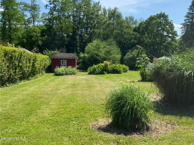 a view of a garden with a house