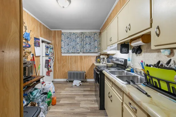 a kitchen with stainless steel appliances granite countertop a sink a stove and a refrigerator
