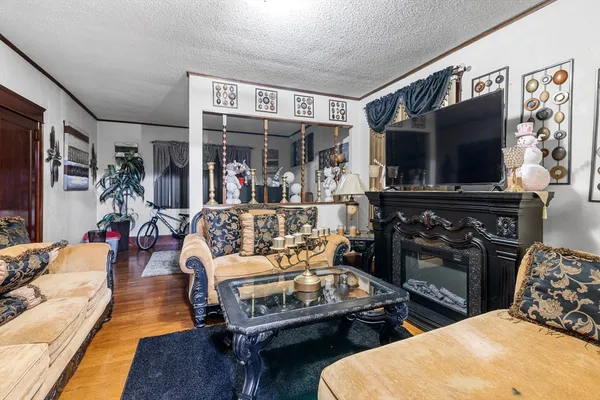 a living room with furniture a flat screen tv and a fireplace