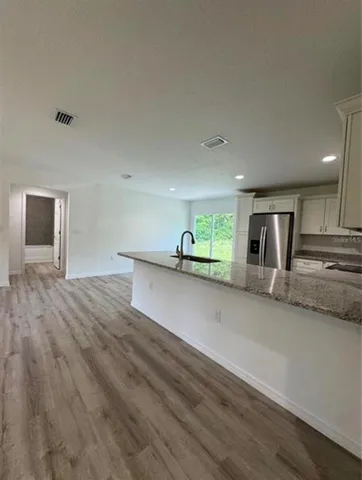 a view of kitchen with stainless steel appliances refrigerator sink and stove