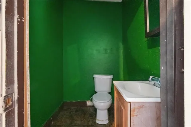 a white toilet sitting next to a small yard
