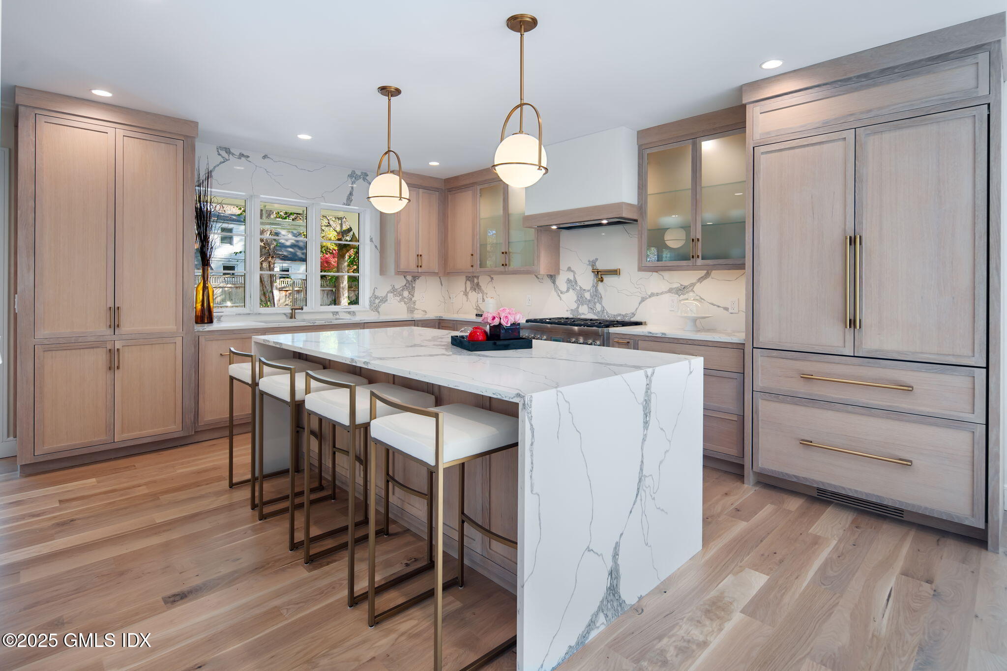 44 Amherst Road Old Greenwich, CT 06870 - Photo 15 of 39 a kitchen with a table chairs refrigerator and wooden floor
