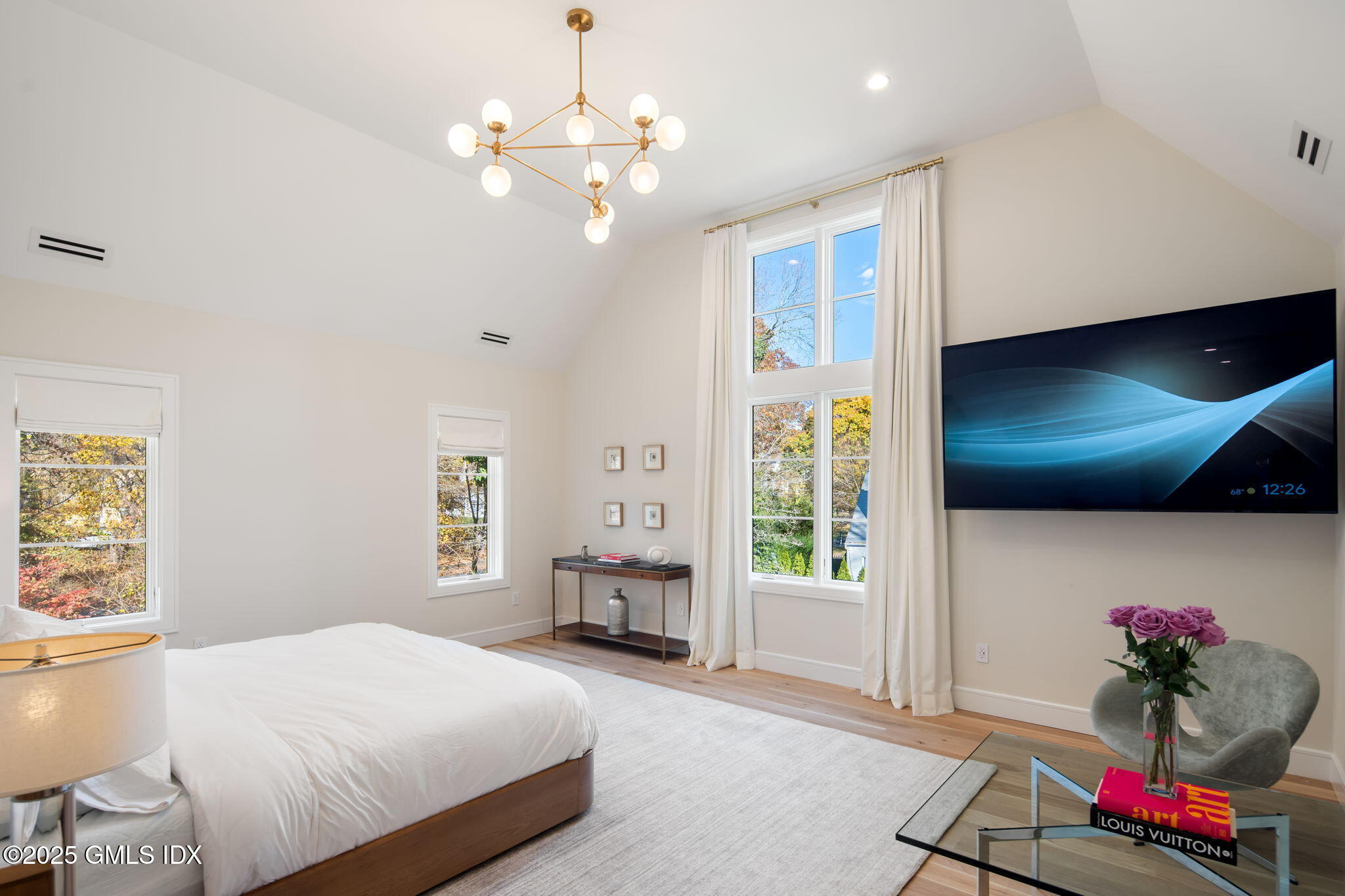 44 Amherst Road Old Greenwich, CT 06870 - Photo 24 of 39 a bedroom with a bed chandelier and a window