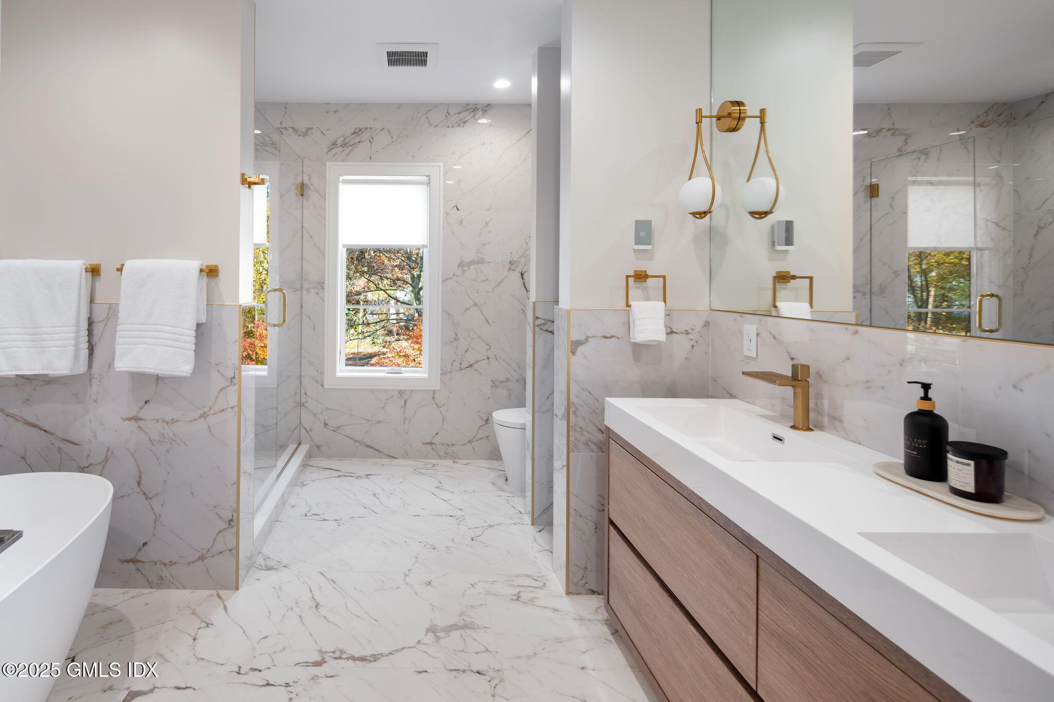 44 Amherst Road Old Greenwich, CT 06870 - Photo 26 of 39 a bathroom with a sink a toilet and shower
