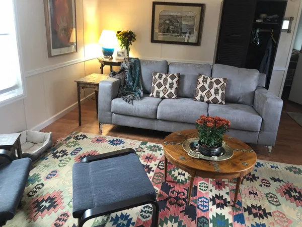 a living room with furniture and a dining table