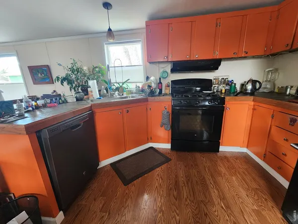 a kitchen with stainless steel appliances granite countertop a refrigerator stove and sink