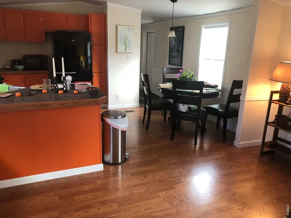 a view of a dining room with furniture and chandelier