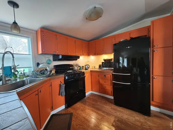 a kitchen with granite countertop stainless steel appliances and wooden cabinets
