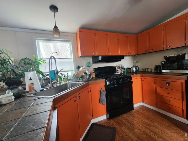a kitchen with stainless steel appliances granite countertop a stove a sink dishwasher and a refrigerator