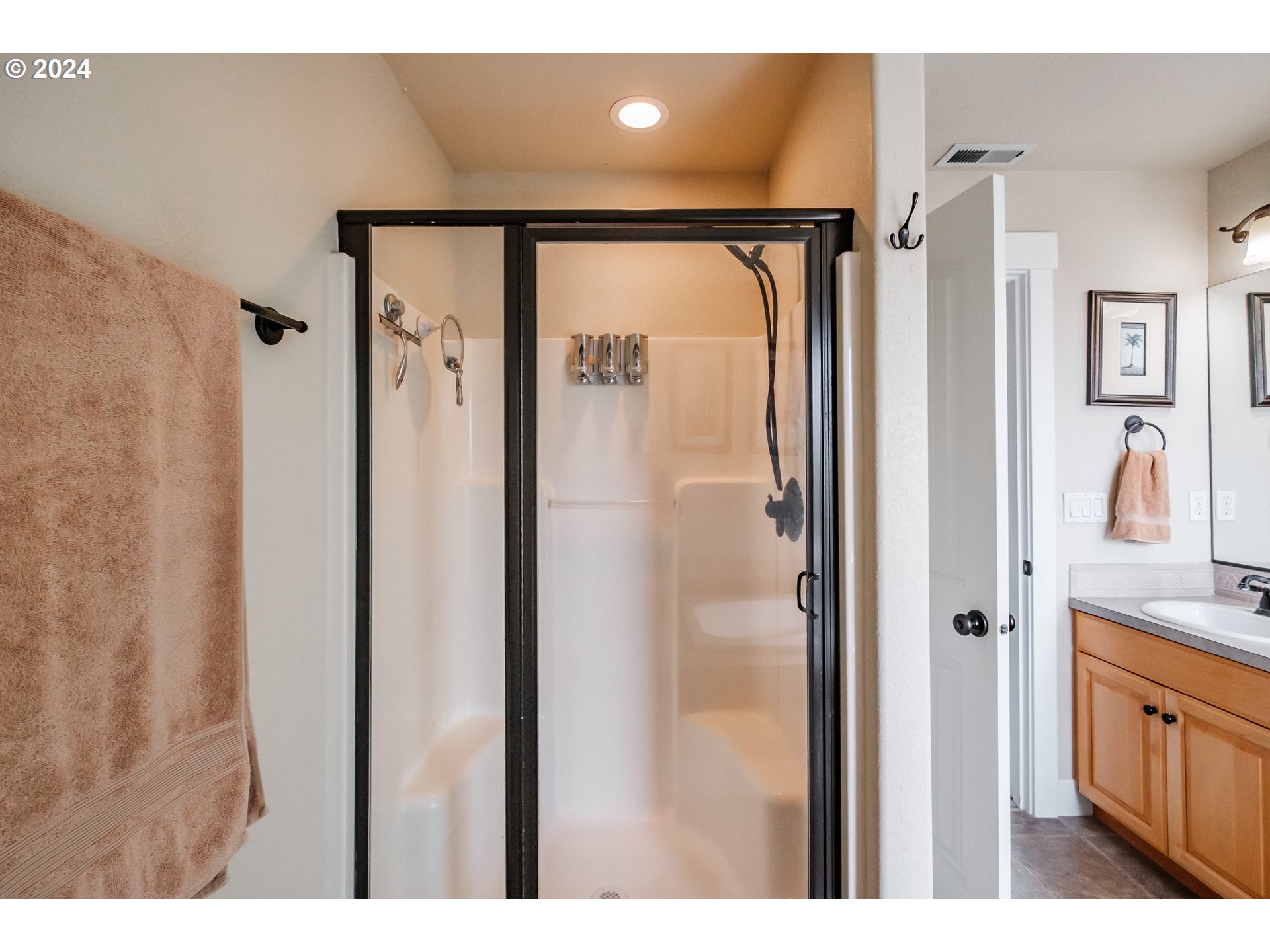 323 Northwest Reed Lane Dallas, OR 97338 - Photo 29 of 40 a bathroom with a glass shower door and a sink