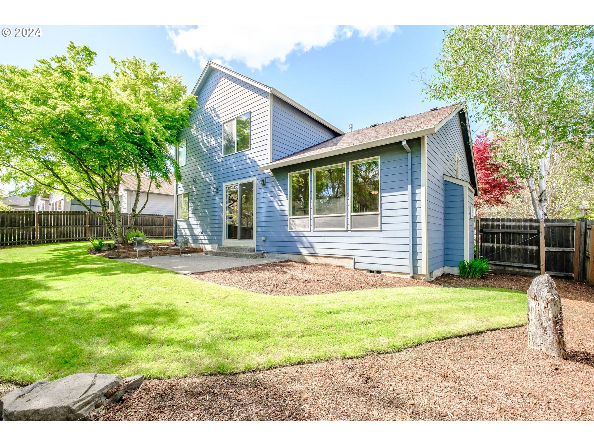 323 Northwest Reed Lane Dallas, OR 97338 - Photo 37 of 40 a view of a house with a backyard and a tree
