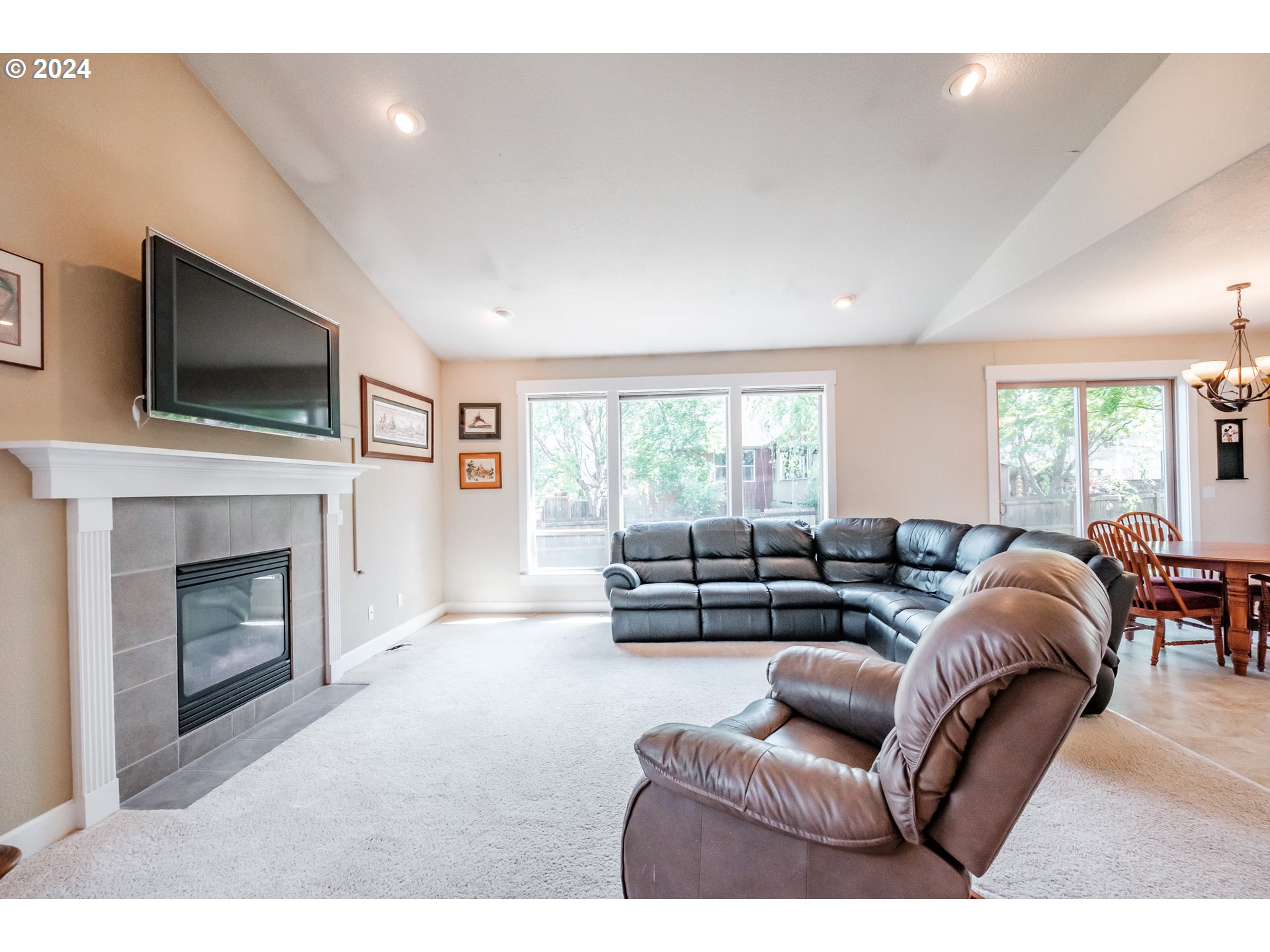 323 Northwest Reed Lane Dallas, OR 97338 - Photo 4 of 40 a living room with furniture a fireplace and a flat screen tv
