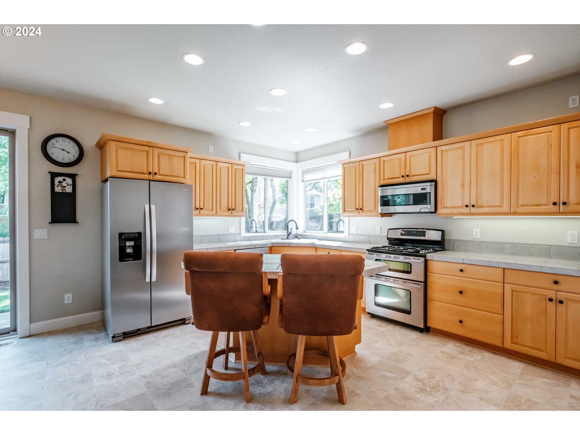 323 Northwest Reed Lane Dallas, OR 97338 - Photo 10 of 40 a kitchen with stainless steel appliances granite countertop a refrigerator a stove microwave cabinets and chairs