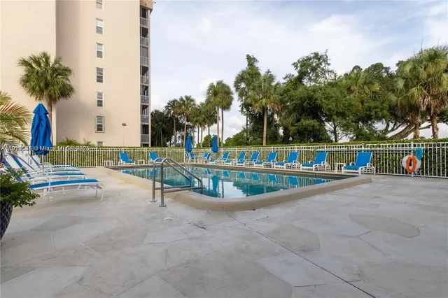 a view of a swimming pool with a lounge chair
