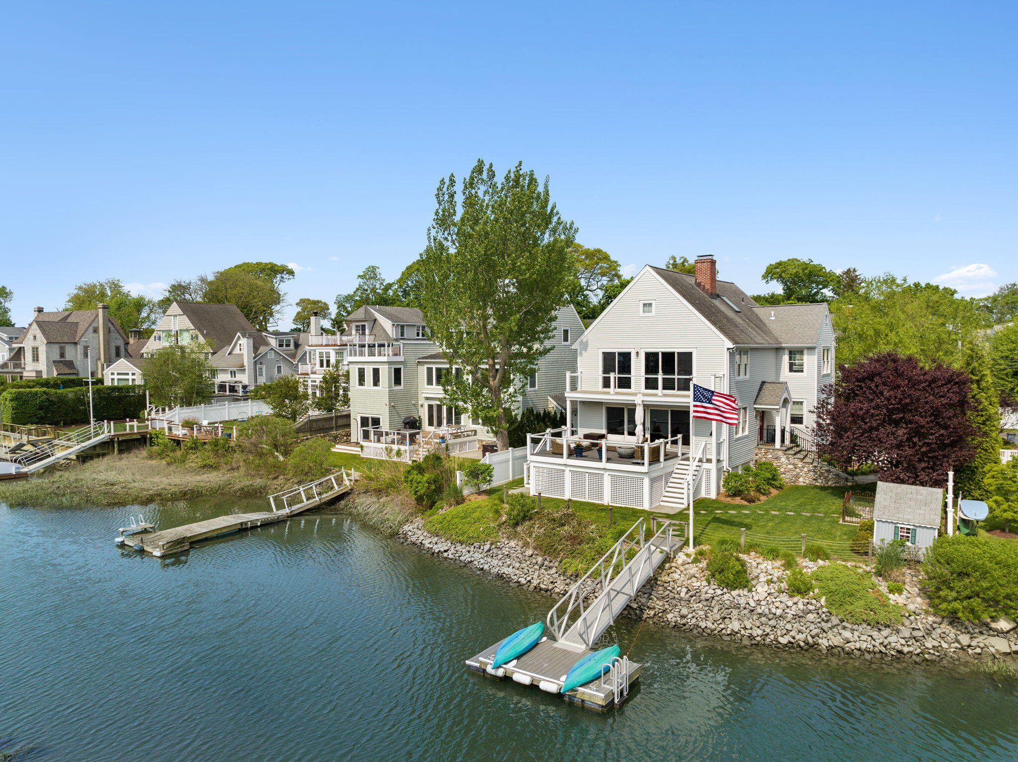 a view of a house with pool lawn chairs and a yard with swimming pool