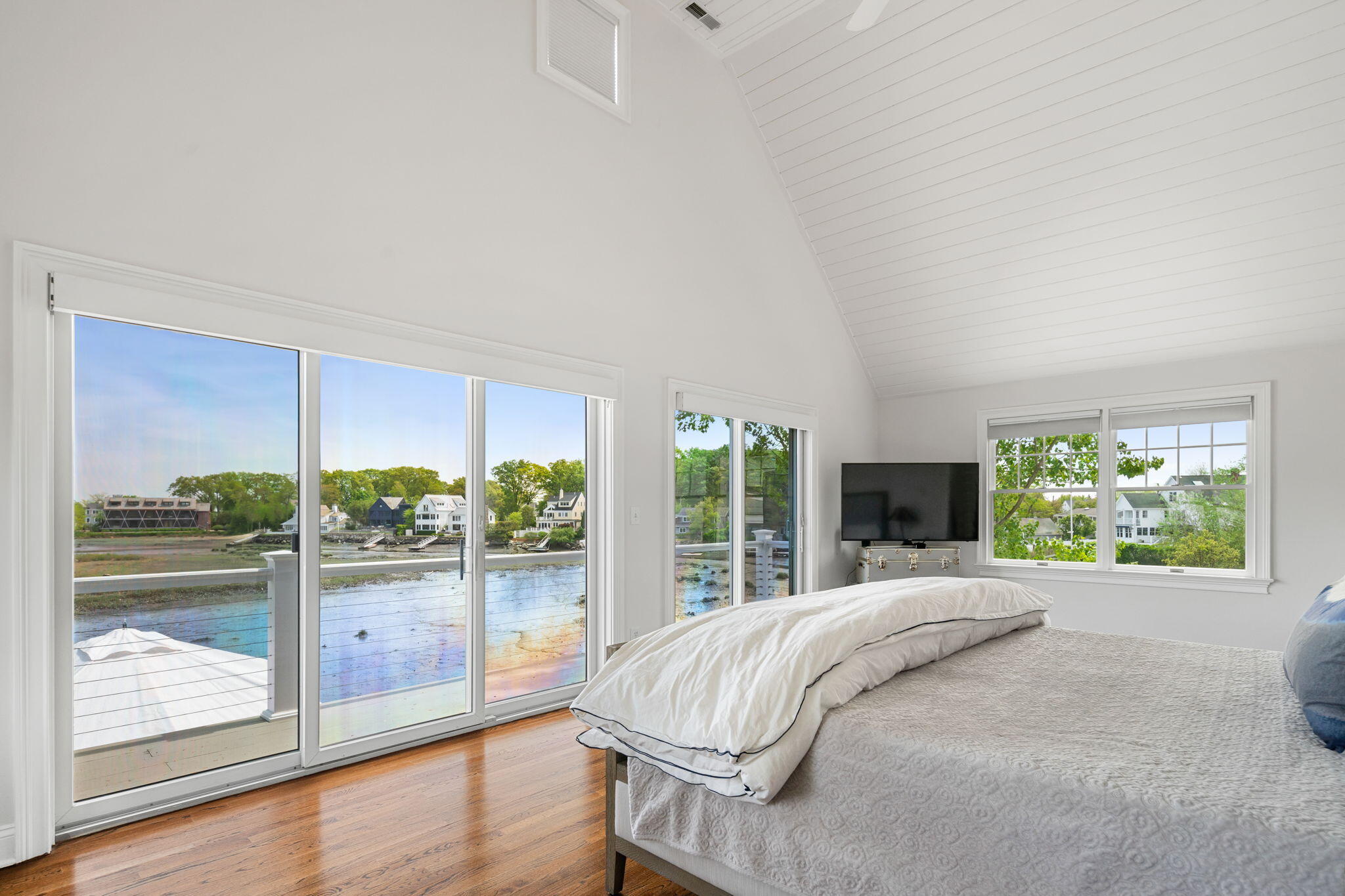 69 Roton Avenue Rowayton, CT 06853 - Photo 22 of 31 a bed sitting in a spacious bedroom next to a large window with outer view