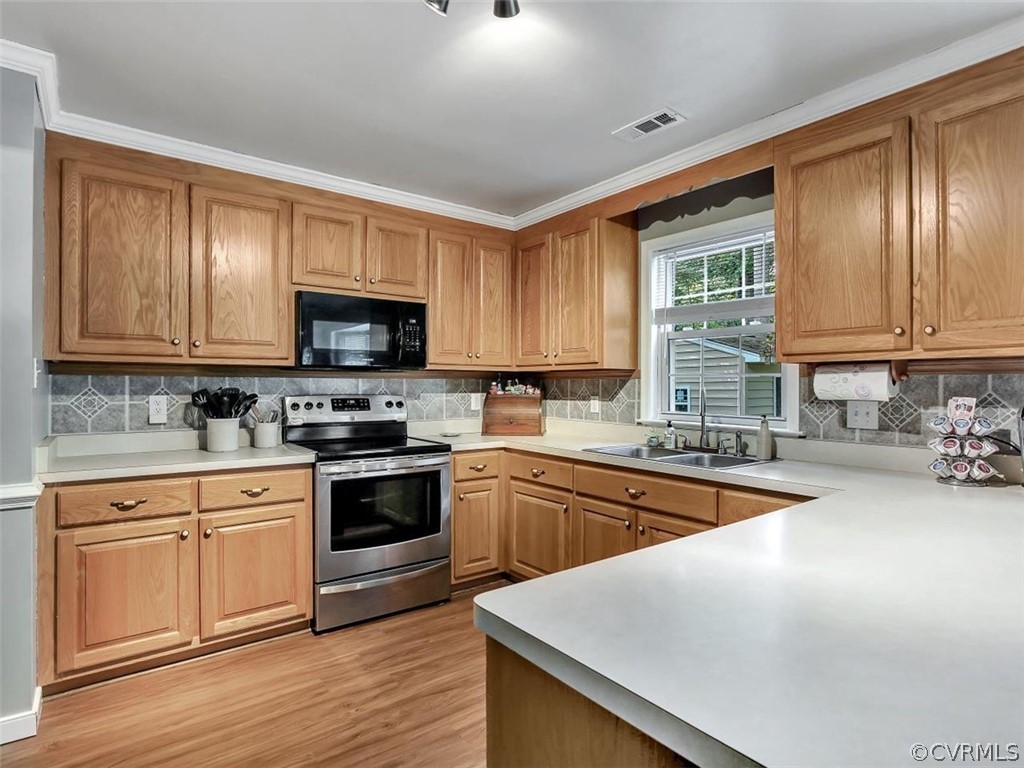 5314 Chestnut Bluff Road Midlothian, VA 23112 - Photo 15 of 31 a kitchen with stainless steel appliances granite countertop a stove a sink dishwasher and a microwave oven with wooden floor