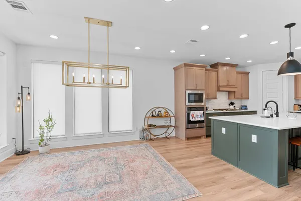 a kitchen with stainless steel appliances granite countertop a sink refrigerator and cabinets