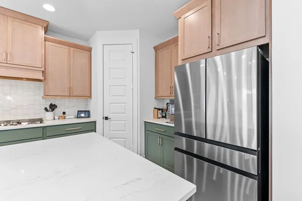 a kitchen with stainless steel appliances a refrigerator sink and cabinets
