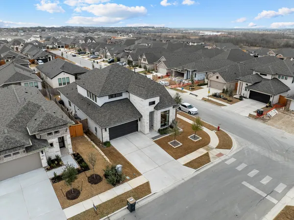 an aerial view of a residential apartment building with parking