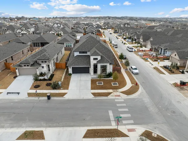 a view of a house with a patio and floor to ceiling window