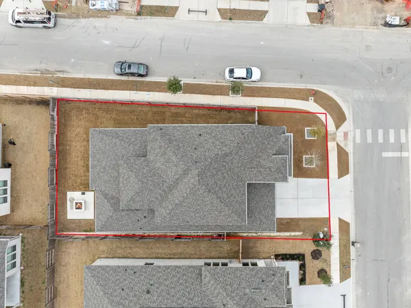 an aerial view of residential building with parking