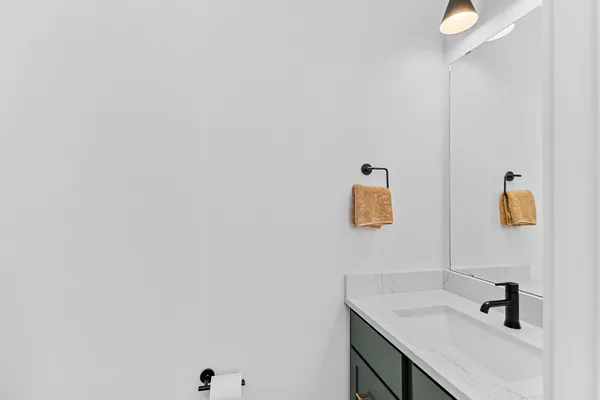 a bathroom with a sink and mirror