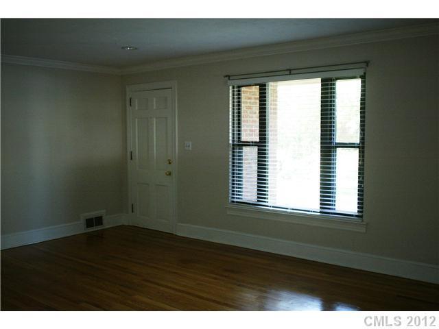 2408 Providence Road, Unit 1 Charlotte, NC 28211 - Photo 3 of 7 a view of an empty room with wooden floor and a window
