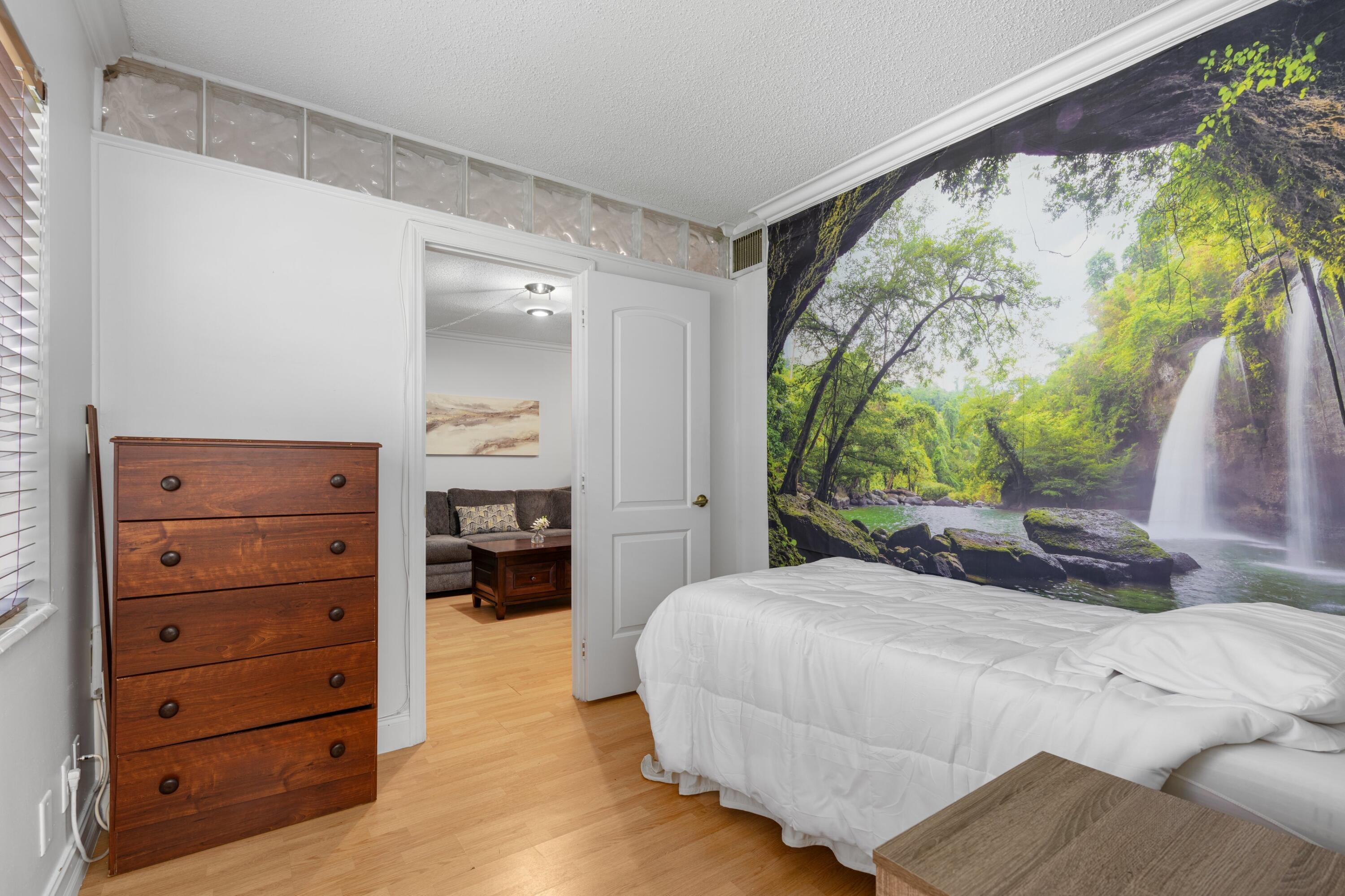 5501 Northwest 2nd Avenue, Unit 213 Boca Raton, FL 33487 - Photo 11 of 17 a bedroom with a bed and a window