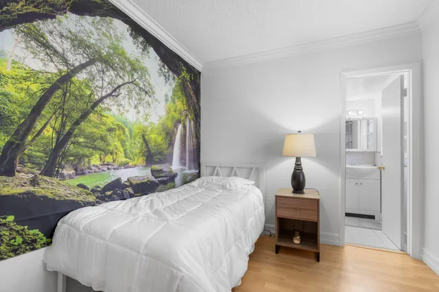 a spacious bedroom with a bed and a window