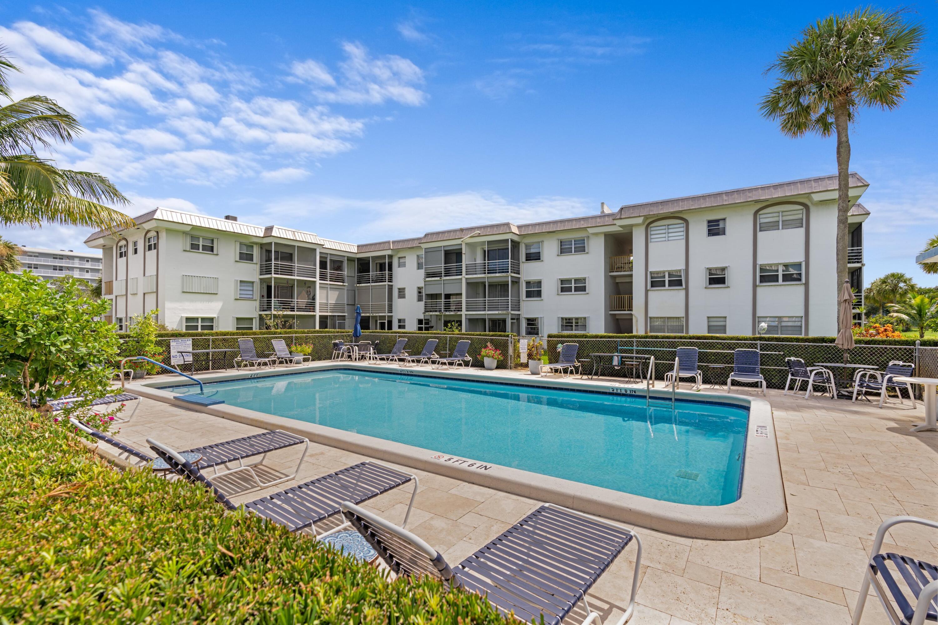 5501 Northwest 2nd Avenue, Unit 213 Boca Raton, FL 33487 - Photo 17 of 17 a view of a swimming pool with a lounge chair