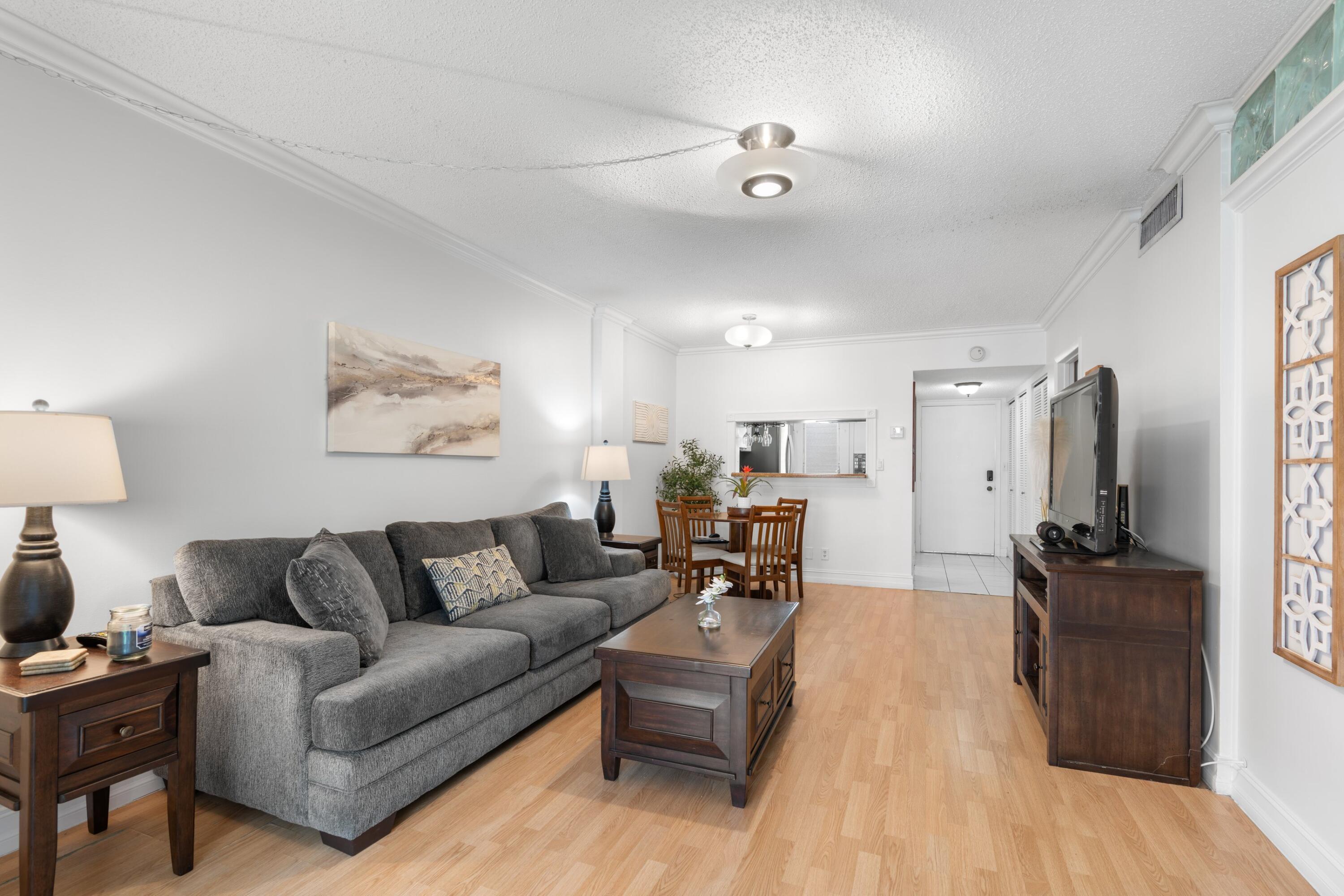 5501 Northwest 2nd Avenue, Unit 213 Boca Raton, FL 33487 - Photo 5 of 17 a living room with furniture and a flat screen tv