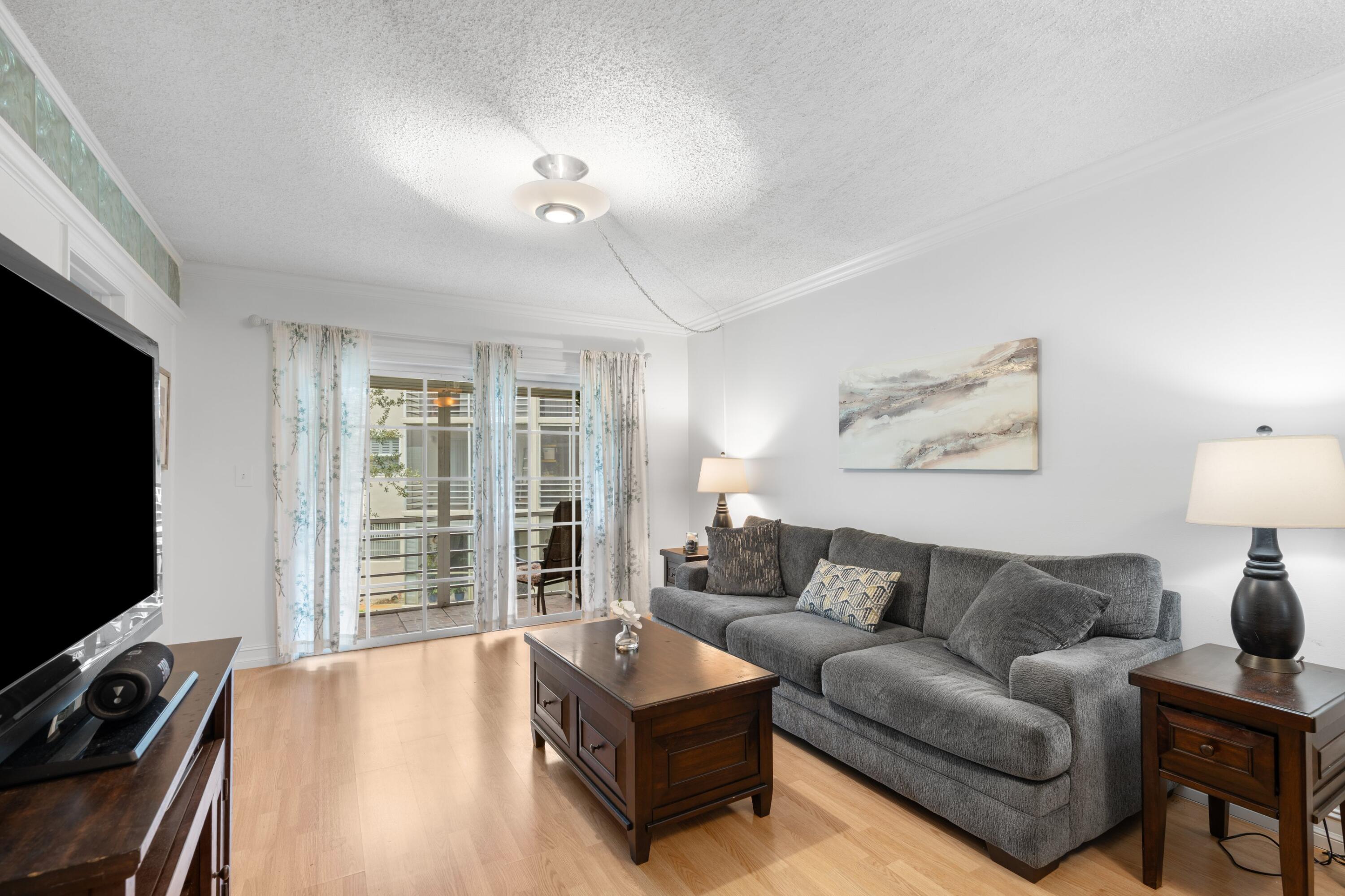 5501 Northwest 2nd Avenue, Unit 213 Boca Raton, FL 33487 - Photo 7 of 17 a living room with furniture and a flat screen tv