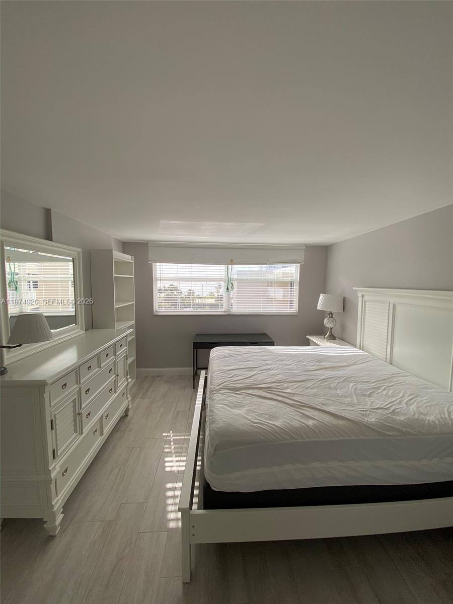 2929 South Ocean Boulevard, Unit 5090 Boca Raton, FL 33432 - Photo 11 of 25 a bedroom with a bed and a dresser