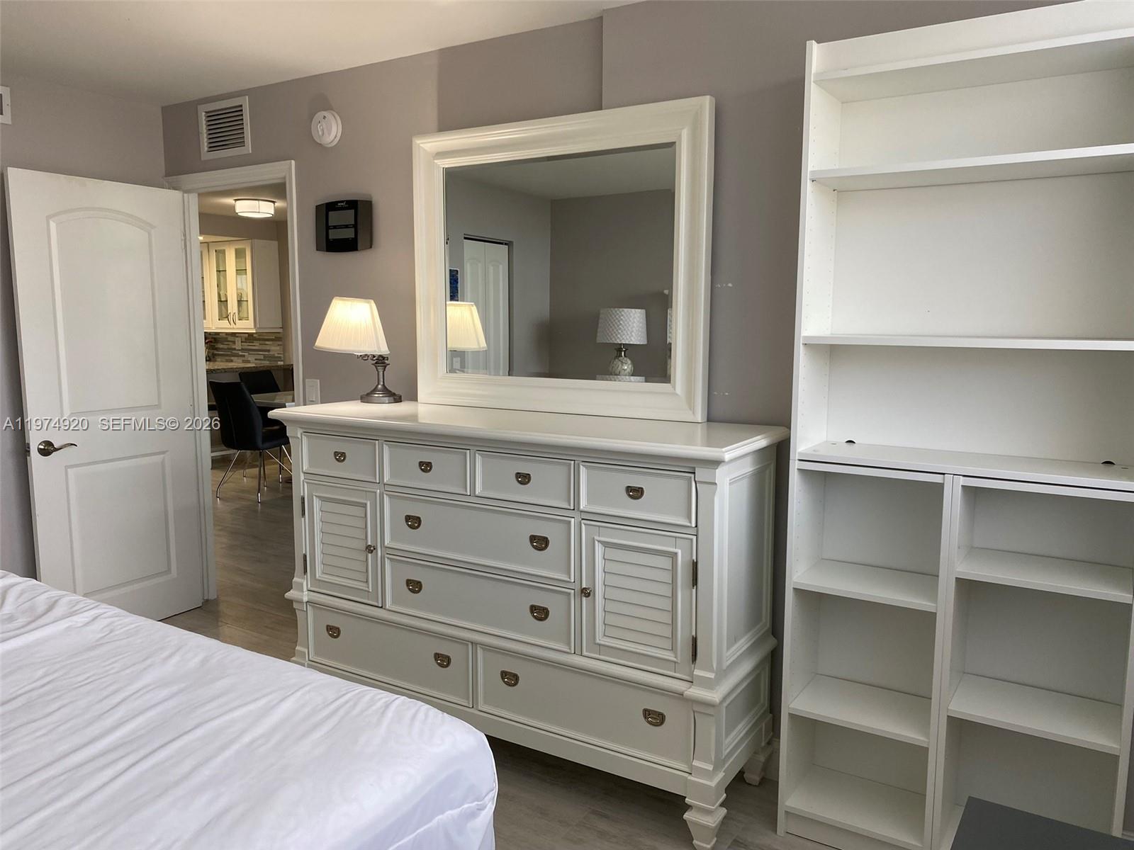 2929 South Ocean Boulevard, Unit 5090 Boca Raton, FL 33432 - Photo 12 of 25 a bedroom with a bed and a cabinets